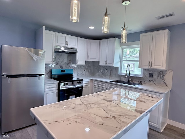1818 Broadway St, Anderson, IN 46012 - kitchen featuring appliances with stainless steel finishes, under cabinet range hood, white cabinets, light wood finished floors, and tasteful backsplash