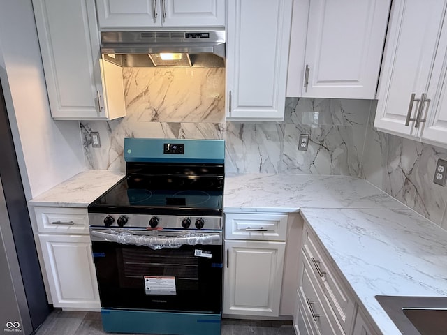1818 Broadway St, Anderson, IN 46012 - kitchen with electric range, under cabinet range hood, white cabinetry, backsplash, and light stone counters