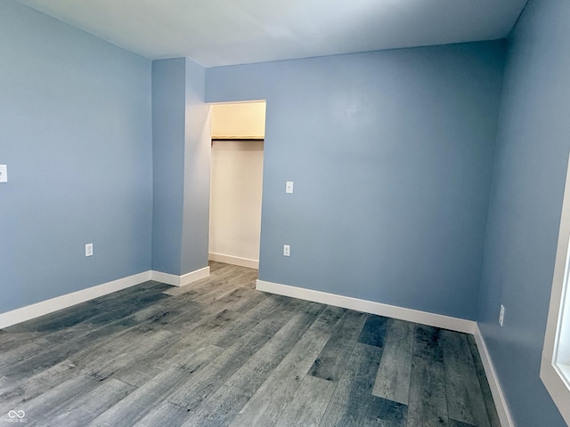 1818 Broadway St, Anderson, IN 46012 - unfurnished bedroom featuring baseboards and dark wood-type flooring
