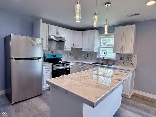 1818 Broadway St, Anderson, IN 46012 - kitchen featuring appliances with stainless steel finishes, under cabinet range hood, white cabinetry, and recessed lighting