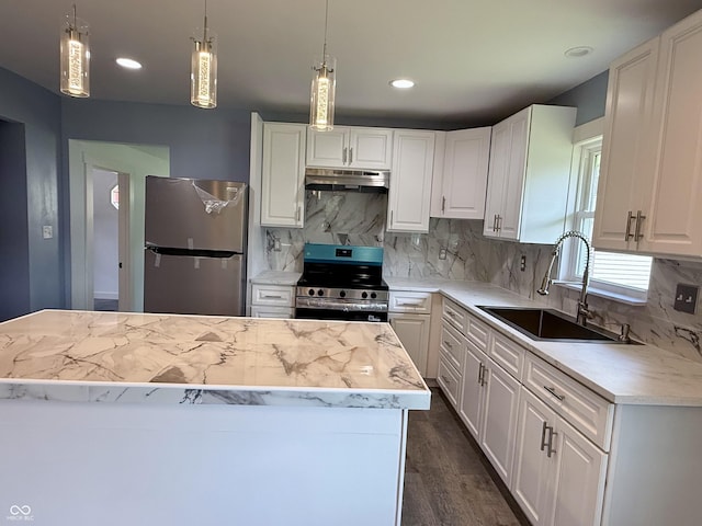 1818 Broadway St, Anderson, IN 46012 - kitchen featuring stainless steel appliances, under cabinet range hood, light countertops, white cabinets, and tasteful backsplash