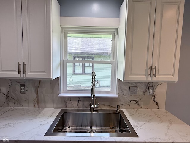 1818 Broadway St, Anderson, IN 46012 - kitchen with white cabinetry, decorative backsplash, and light stone countertops