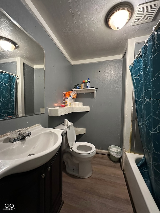 1129 N Pershing Ave, Indianapolis, IN 46222 - full bathroom with vanity, wood finished floors, a textured ceiling, and shower / bath combination with curtain