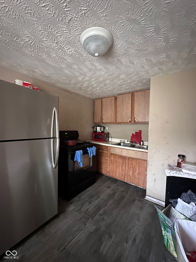 1129 N Pershing Ave, Indianapolis, IN 46222 - kitchen with freestanding refrigerator, black electric range, a textured ceiling, dark wood-type flooring, and light countertops