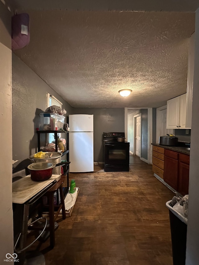 1129 N Pershing Ave, Indianapolis, IN 46222 - kitchen with freestanding refrigerator, black range with electric cooktop, dark wood finished floors, dark countertops, and white cabinetry