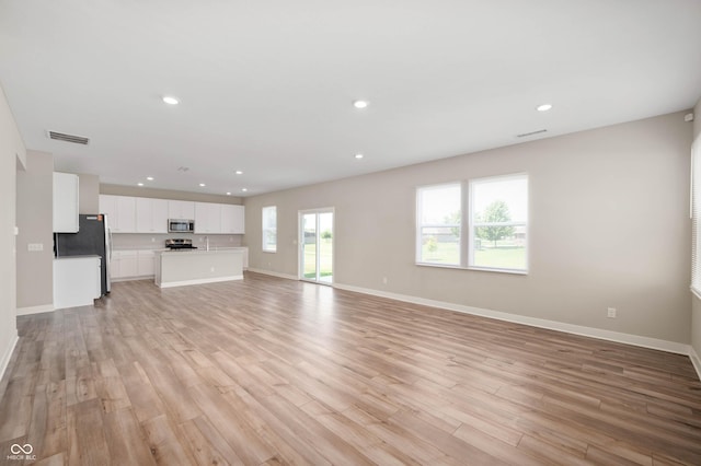 7510 Hillway Dr, Camby, IN 46113 - unfurnished living room with light wood-type flooring and recessed lighting