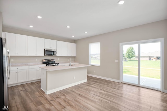 7510 Hillway Dr, Camby, IN 46113 - kitchen featuring stainless steel appliances, light countertops, light wood-style floors, recessed lighting, and white cabinetry