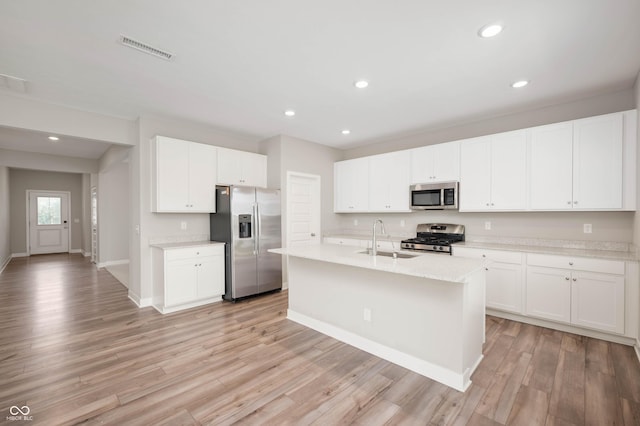 7510 Hillway Dr, Camby, IN 46113 - kitchen with appliances with stainless steel finishes, light wood-style floors, recessed lighting, an island with sink, and white cabinets