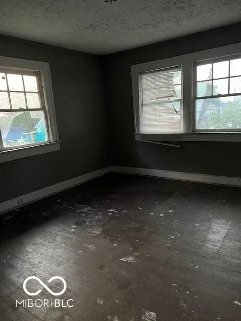 3701 E Vermont St, Indianapolis, IN 46201 - spare room with a textured ceiling and baseboards