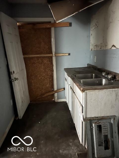 3701 E Vermont St, Indianapolis, IN 46201 - kitchen with unfinished concrete flooring, white cabinets, and dark countertops