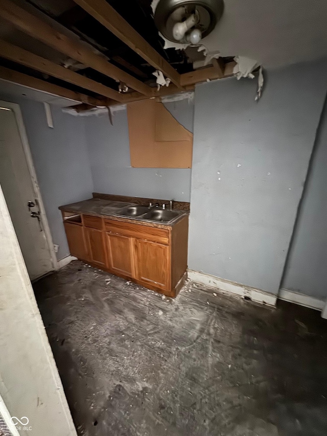 3701 E Vermont St, Indianapolis, IN 46201 - kitchen featuring brown cabinets and concrete floors