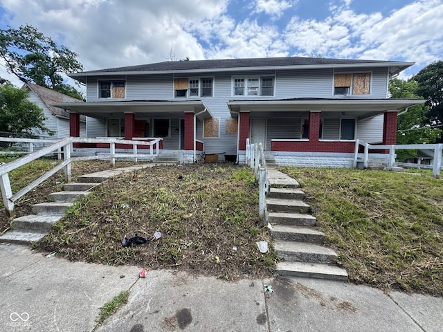 3701 E Vermont St, Indianapolis, IN 46201 - view of front of property with a porch, brick siding, and stairway