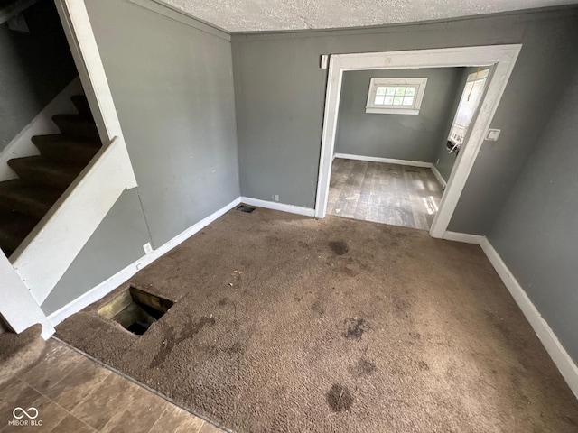 3701 E Vermont St, Indianapolis, IN 46201 - empty room with stairs, a textured ceiling, and carpet floors