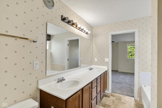 11961 Driftstone Dr, Fishers, IN 46037 - full bathroom featuring double vanity, wallpapered walls, a garden tub, and a textured ceiling