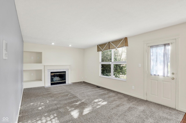 11961 Driftstone Dr, Fishers, IN 46037 - unfurnished living room with a tiled fireplace, carpet floors, and recessed lighting