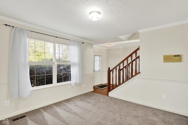 11961 Driftstone Dr, Fishers, IN 46037 - carpeted spare room with ornamental molding, stairway, and a textured ceiling
