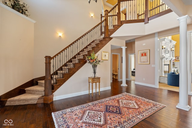 1130 Kingswood Rd S, West Lafayette, IN 47906 - foyer featuring decorative columns, hardwood / wood-style floors, a towering ceiling, and stairway