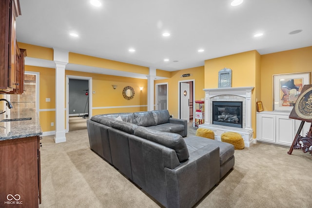 1130 Kingswood Rd S, West Lafayette, IN 47906 - living area with light carpet, ornate columns, a fireplace, and recessed lighting
