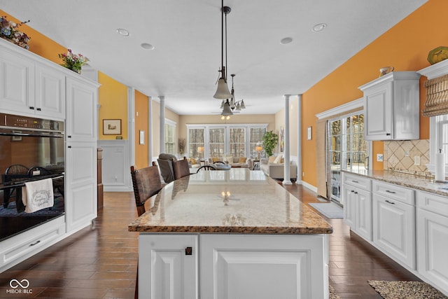 1130 Kingswood Rd S, West Lafayette, IN 47906 - kitchen with open floor plan, tasteful backsplash, dark wood-style flooring, white cabinets, and recessed lighting