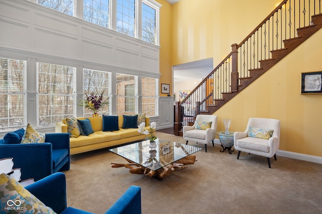 1130 Kingswood Rd S, West Lafayette, IN 47906 - carpeted living room featuring a high ceiling and stairway