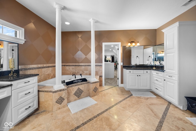 1130 Kingswood Rd S, West Lafayette, IN 47906 - bathroom featuring decorative columns, inlaid floor details, vanity, and a bath