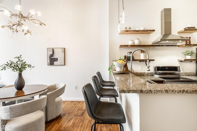 624 E Walnut St Unit 48, Indianapolis, IN 46204 - kitchen featuring exhaust hood, stainless steel range with electric stovetop, open shelves, hardwood / wood-style floors, and light stone countertops