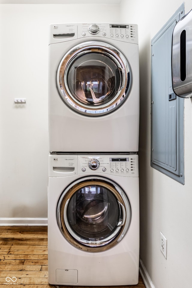 624 E Walnut St Unit 48, Indianapolis, IN 46204 - washroom featuring stacked washer and clothes dryer and wood finished floors