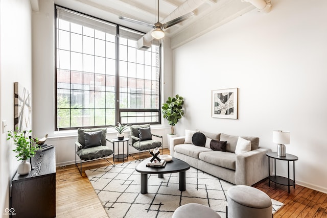 624 E Walnut St Unit 48, Indianapolis, IN 46204 - living room with hardwood / wood-style floors, beamed ceiling, a towering ceiling, and a ceiling fan