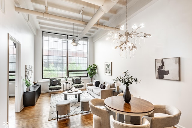 624 E Walnut St Unit 48, Indianapolis, IN 46204 - dining area featuring beam ceiling, wood finished floors, a high ceiling, a chandelier, and coffered ceiling