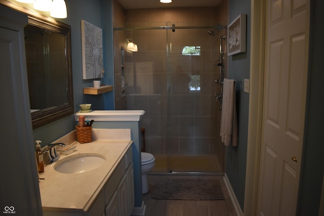 7357 Lake Lakota Dr, Indianapolis, IN 46217 - bathroom with wood finished floors, a stall shower, and vanity