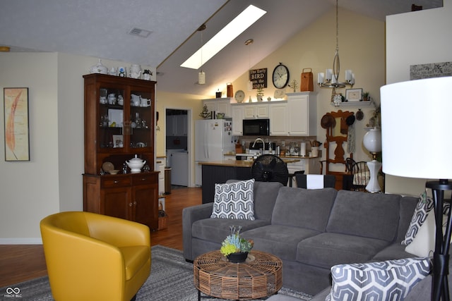 7357 Lake Lakota Dr, Indianapolis, IN 46217 - living area featuring a skylight, dark wood-style floors, and high vaulted ceiling