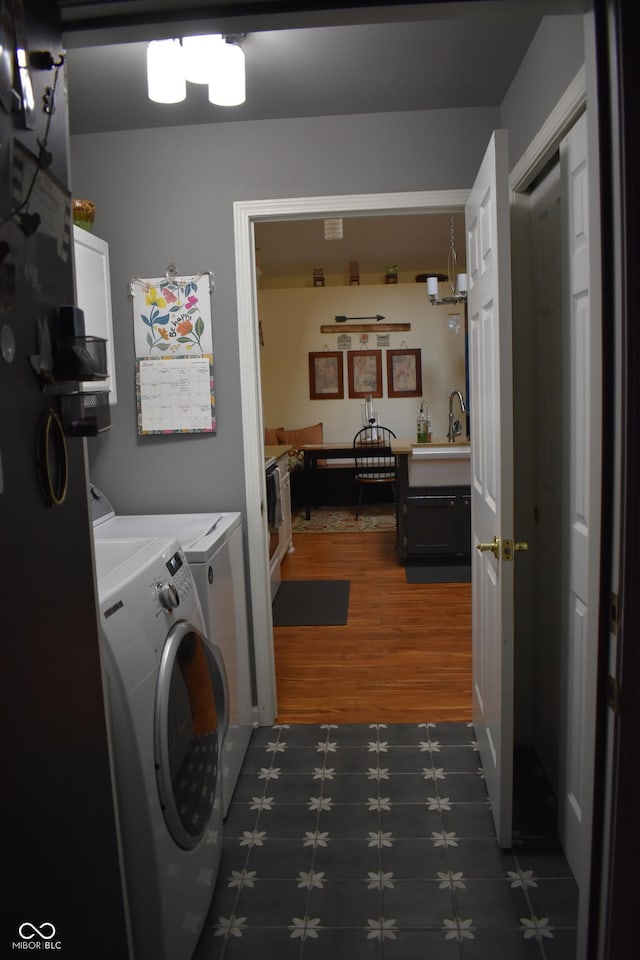 7357 Lake Lakota Dr, Indianapolis, IN 46217 - laundry room featuring washer and clothes dryer and dark wood-style floors