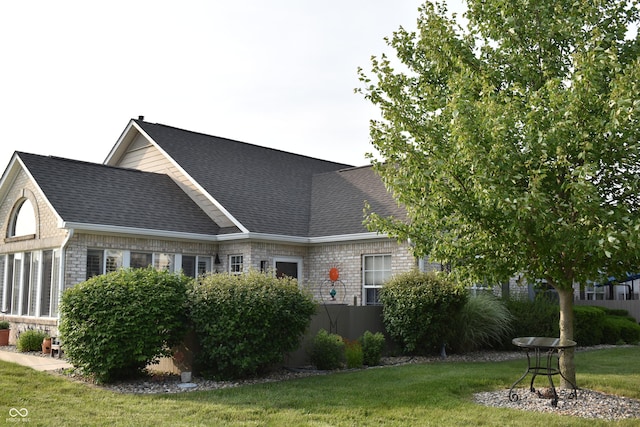7357 Lake Lakota Dr, Indianapolis, IN 46217 - rear view of property featuring a yard and a shingled roof