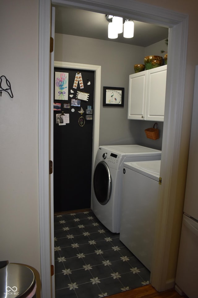 7357 Lake Lakota Dr, Indianapolis, IN 46217 - washroom with cabinet space, washing machine and clothes dryer, and dark flooring