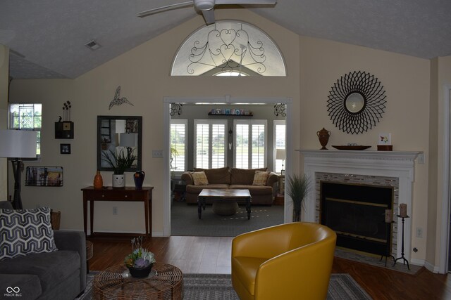 7357 Lake Lakota Dr, Indianapolis, IN 46217 - living area with wood finished floors, ceiling fan, a fireplace with flush hearth, healthy amount of natural light, and high vaulted ceiling