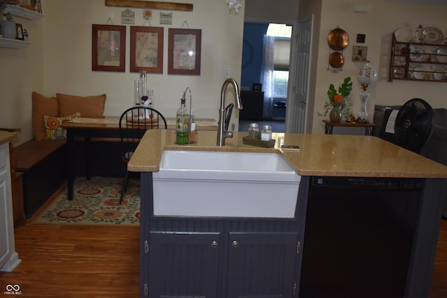 7357 Lake Lakota Dr, Indianapolis, IN 46217 - kitchen featuring dishwasher, wood finished floors, and a kitchen island with sink