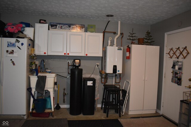 7357 Lake Lakota Dr, Indianapolis, IN 46217 - garage with freestanding refrigerator and water heater