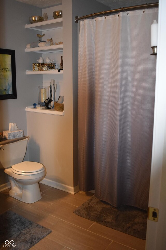 7357 Lake Lakota Dr, Indianapolis, IN 46217 - bathroom featuring wood finished floors and curtained shower