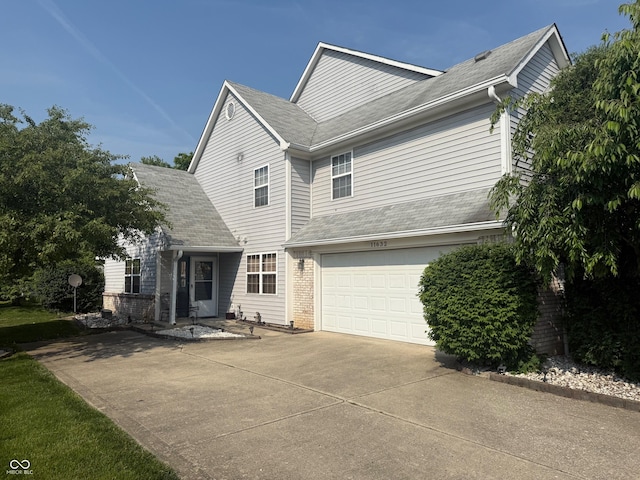11632 Coastal Way, Indianapolis, IN 46229 - traditional-style house with driveway, brick siding, a garage, and a shingled roof