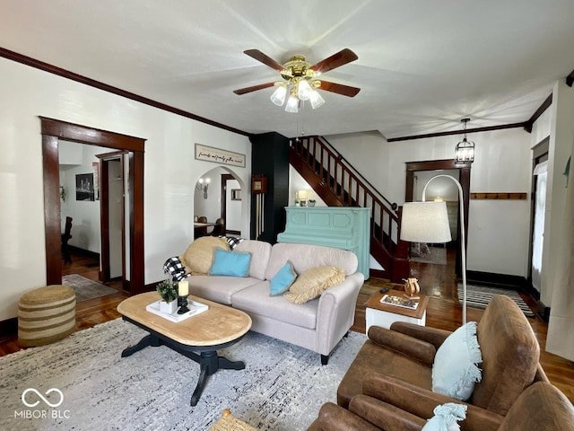 251 N St, Danville, IN 46122 - living area featuring arched walkways, ornamental molding, wood finished floors, stairs, and a ceiling fan