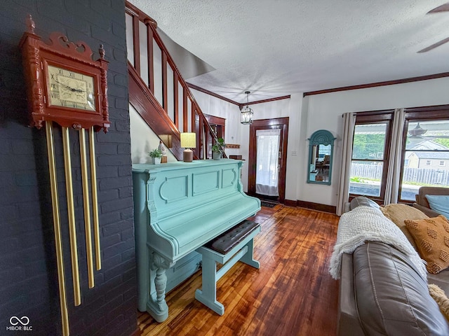 251 N St, Danville, IN 46122 - living room featuring a textured ceiling, wood finished floors, stairway, ornamental molding, and a ceiling fan