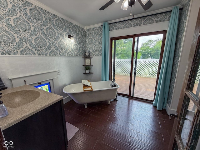 251 N St, Danville, IN 46122 - bathroom with ornamental molding, a freestanding tub, a ceiling fan, wallpapered walls, and wood finished floors