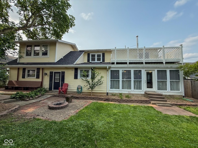 251 N St, Danville, IN 46122 - back of property featuring entry steps, a fire pit, roof with shingles, and a patio area