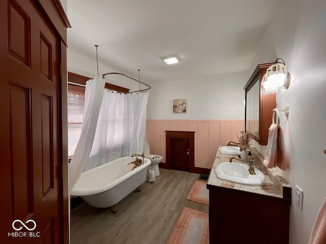 251 N St, Danville, IN 46122 - full bathroom with wood finished floors, double vanity, and wainscoting