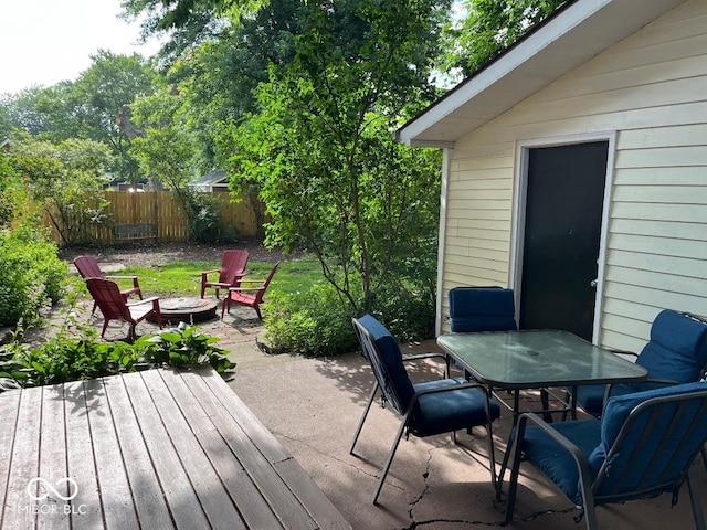 251 N St, Danville, IN 46122 - wooden deck with outdoor dining space, an outdoor fire pit, and a patio area