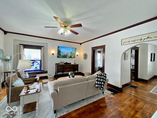 251 N St, Danville, IN 46122 - living room with arched walkways, wood finished floors, ornamental molding, and a ceiling fan