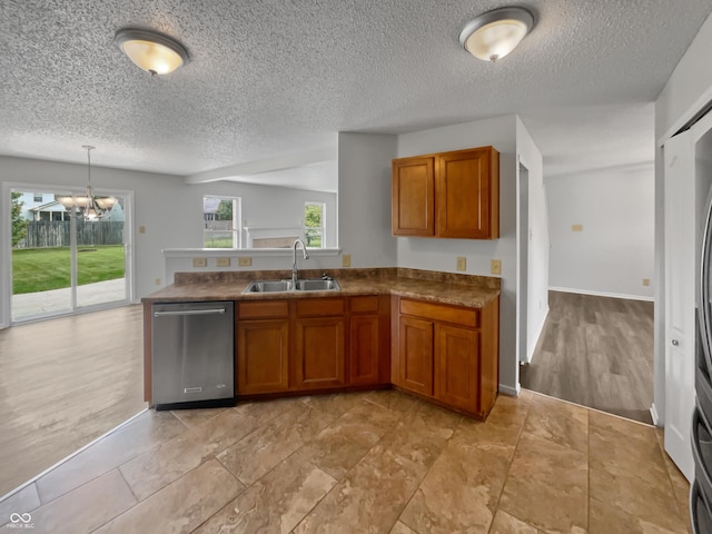 3445 Brandenburg Blvd, Indianapolis, IN 46239 - kitchen with dishwasher, brown cabinets, a peninsula, dark countertops, and a chandelier
