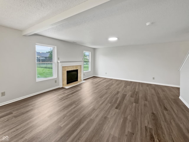 3445 Brandenburg Blvd, Indianapolis, IN 46239 - unfurnished living room with dark wood-type flooring, a textured ceiling, a fireplace, and beam ceiling