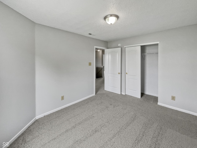 3445 Brandenburg Blvd, Indianapolis, IN 46239 - unfurnished bedroom featuring carpet, a textured ceiling, and a closet