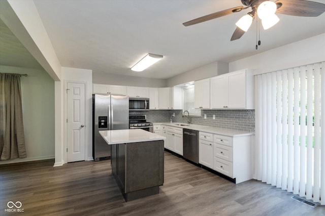 802 Lawrence Ave, Indianapolis, IN 46227 - kitchen featuring appliances with stainless steel finishes, light countertops, backsplash, and white cabinets